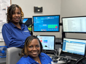 picture of two women in front of computer screens