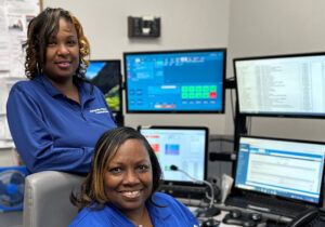 picture of two women in front of computer screens
